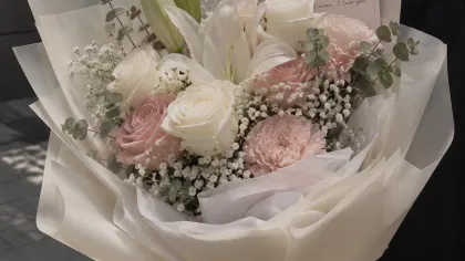 Bó hồng phấn, hồng trắng, lily trắng và baby gói giấy trắng, người cầm đứng ngoài phố